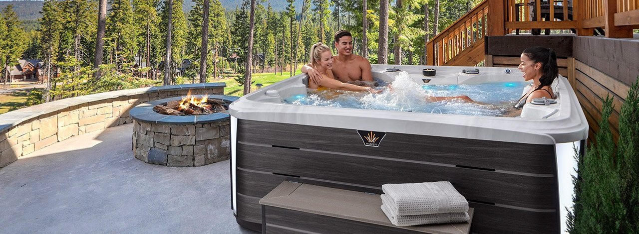 3 people enjoying a Marquis hot tub outside