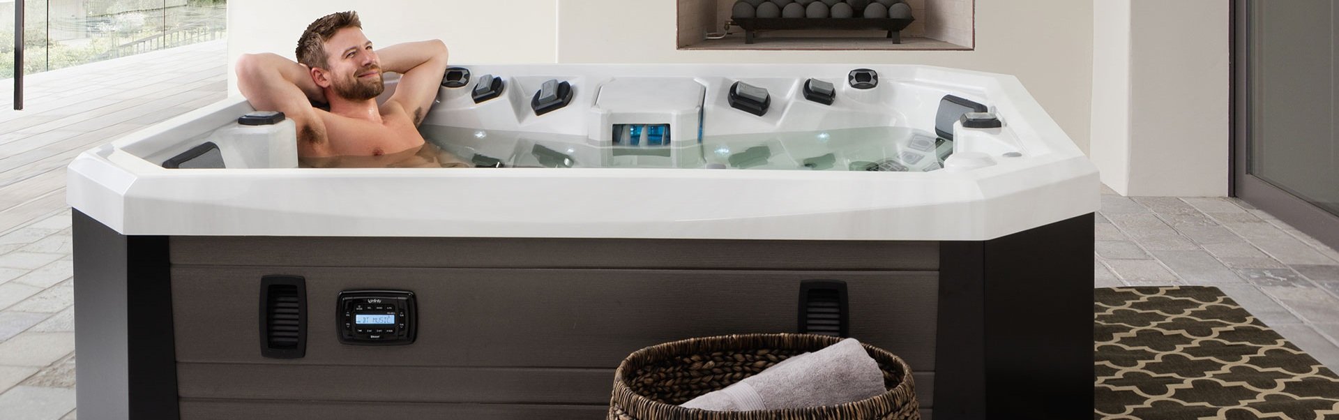 A man relaxing in a plug and play hot tub