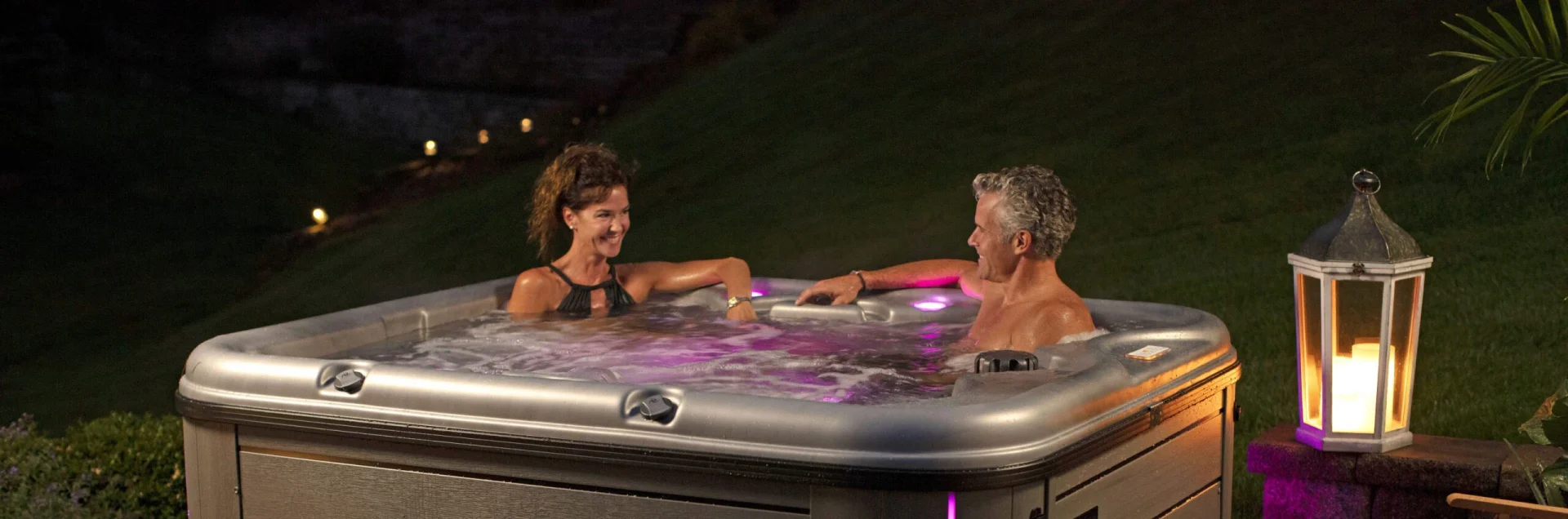 A couple enjoying an evening soak in their Nordic Hot Tub